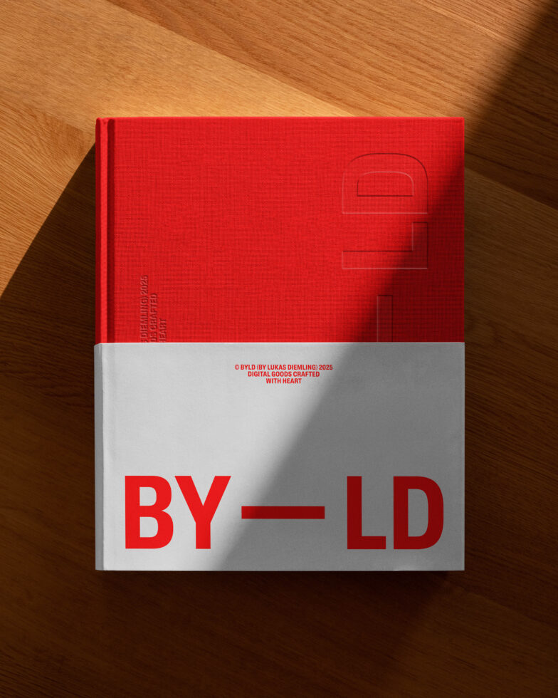 Red book on wooden table featuring bold text BY LD, suitable for mockup design use. Minimalist style ideal for digital designers. Modern and stylish cover.