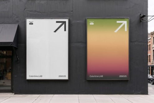 Outdoor mockup with two posters on dark wall featuring minimalist design. One poster is white with a pixel arrow and the other has a gradient background.