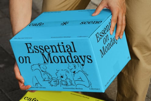 Man holding blue cardboard box featuring Essential on Mondays design. Ideal for mockup, packaging, graphics. Vibrant colors, engaging layout.