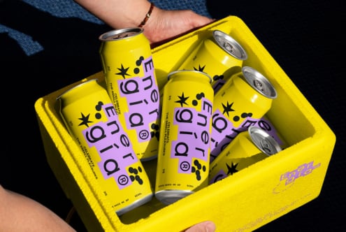 Six vibrant yellow energy drink cans with purple labels in a matching yellow box, perfect for branding, packaging mockup, product design for designers.