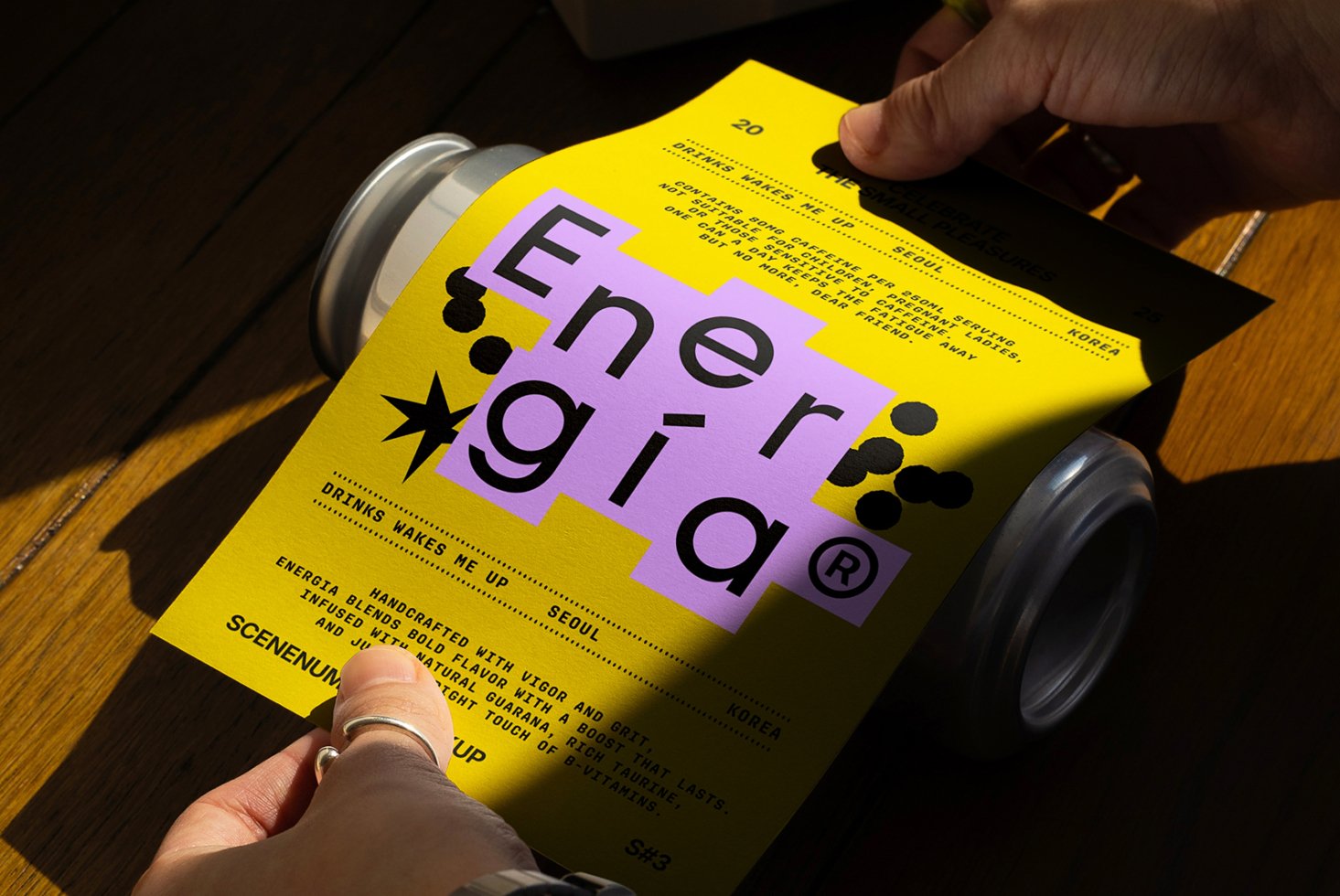 Bright yellow flyer design with bold black typography and purple highlights, held over a can. Ideal for modern mockups and graphic templates for designers.