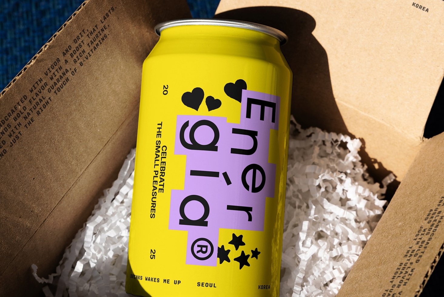 Yellow energy drink can in cardboard box with paper shreds vibrant packaging design modern typography beverage branding mockup ideal for designers graphics templates