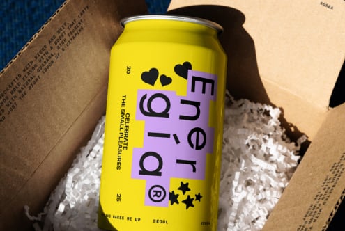 Yellow energy drink can in cardboard box with paper shreds vibrant packaging design modern typography beverage branding mockup ideal for designers graphics templates