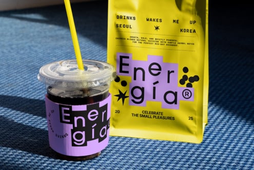 Coffee packaging mockup featuring vibrant design with bold typography. Includes coffee cup and bag on a textured surface. Ideal for graphic designers.