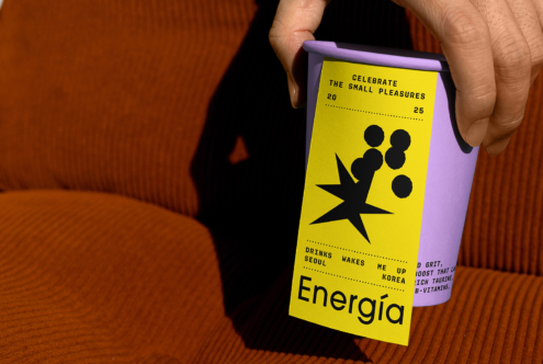 Purple coffee cup with vibrant energy drink label design featuring bold black typography and graphics ideal for mockup showcase or graphic projects.