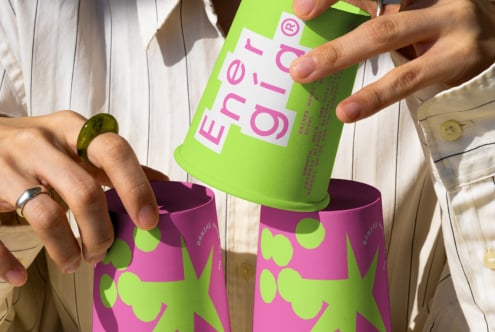 Hands holding colorful cups with bold brand logo graphic design packaging modern vibrant colors creative template for designers branding mockup.
