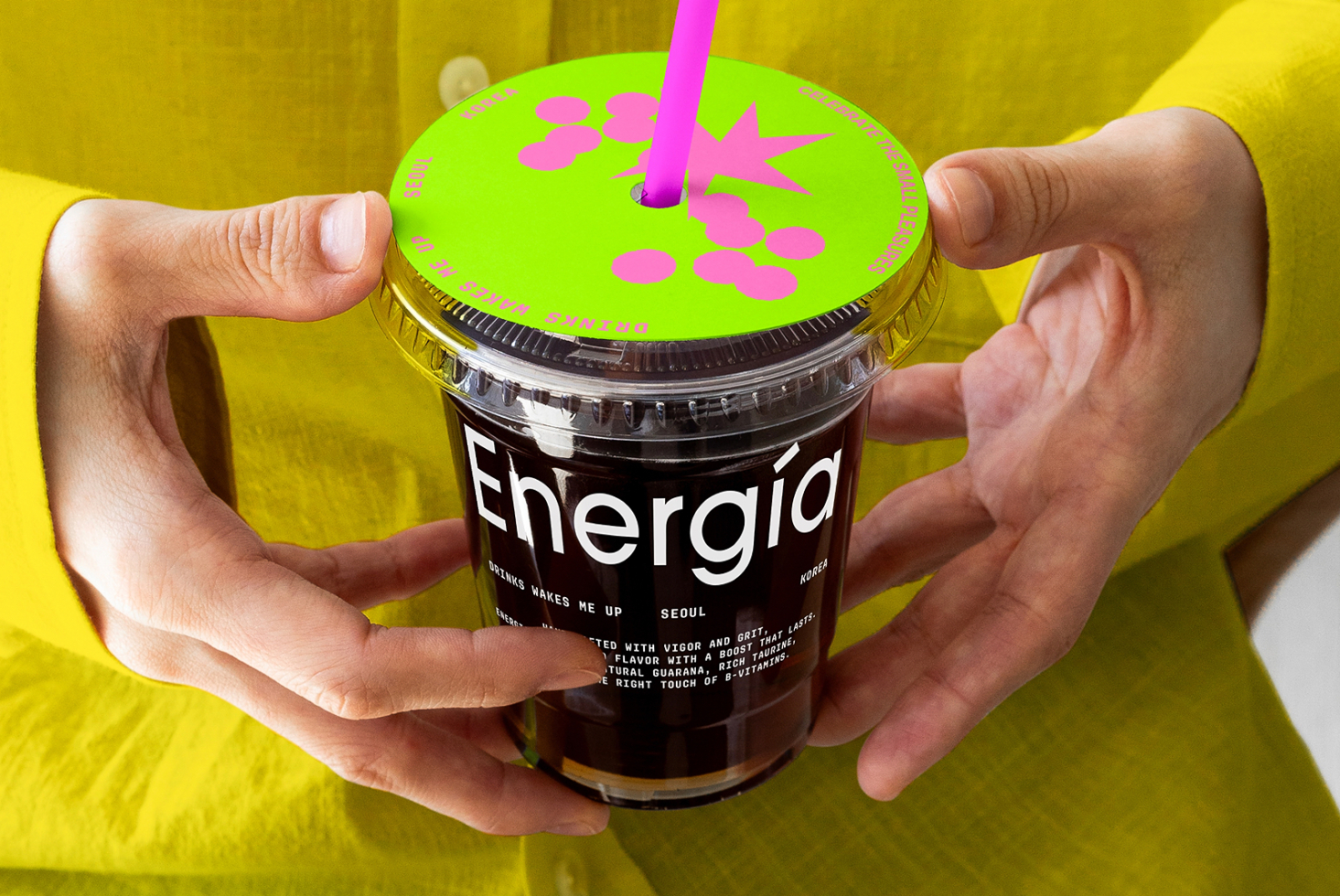 Person holding a coffee cup with vibrant branding and typography. Ideal for designers seeking unique mockup templates for beverage packaging design.