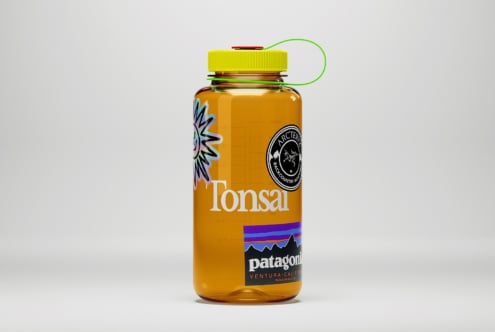 Orange water bottle mockup featuring vibrant graphic designs and logos ideal for branding designers template marketing outdoor gear lifestyle SEO