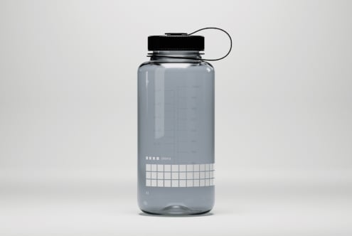 Clear water bottle mockup with black cap and grid design suitable for product designers and template creators looking for realistic presentation.