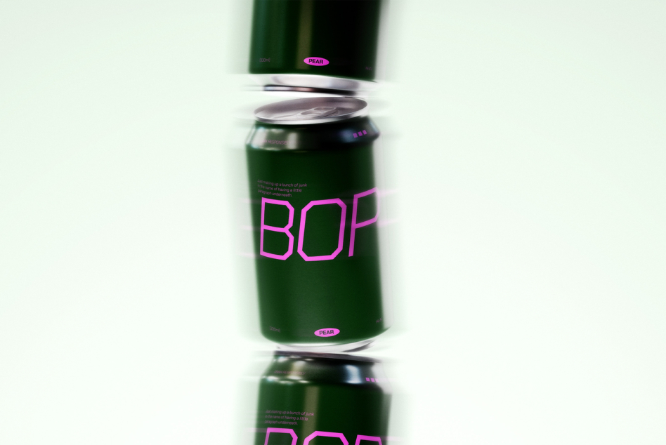 Single green beverage can with neon pink BOP logo, metallic lid, blurred background