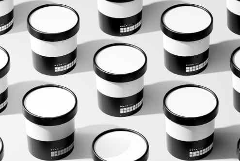 Minimalist packaging mockup featuring black and white cylindrical containers arranged in a grid pattern for product design and branding projects.