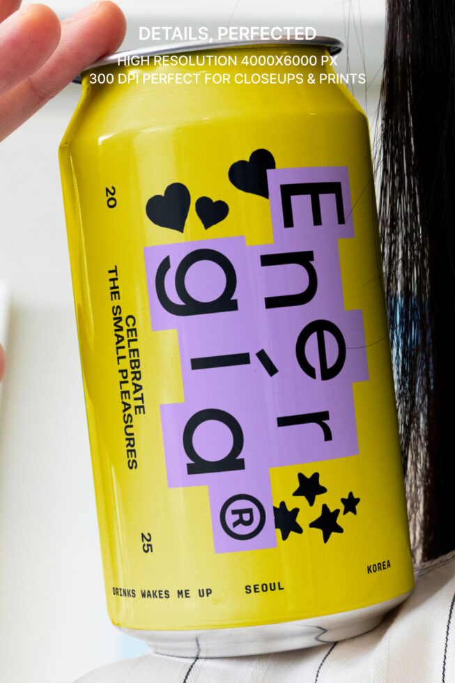 Closeup of a vibrant yellow beverage can featuring stylized text and black heart motifs on a purple label; perfect for product mockup designs.