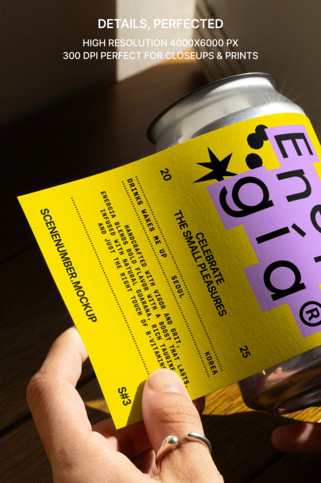 Hand holding a yellow card with text over metal can mockup. High-resolution design asset for labels or branding. Perfect for graphic designers.
