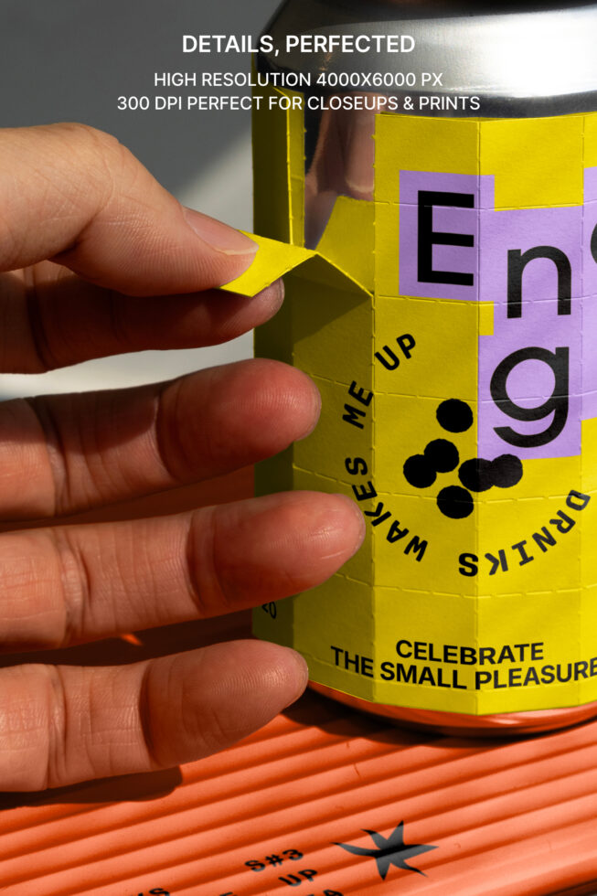 Closeup of a hand peeling a colorful label from a can. High-resolution image ideal for packaging mockups, graphic design inspiration, and templates.