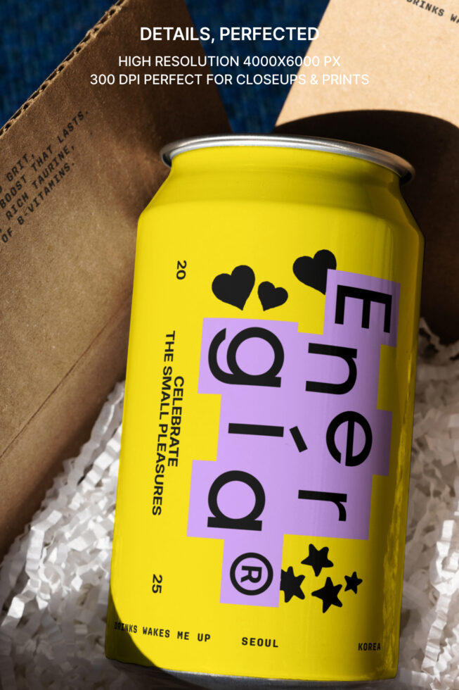 Yellow soda can with modern purple label design featuring black hearts and stars, placed in cardboard box, high-resolution mockup for design projects.