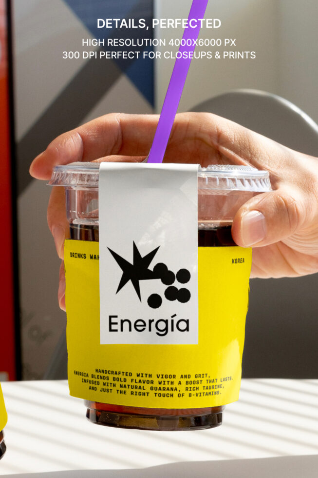 Hand holding a clear plastic cup with yellow label featuring the word Energía. Purple straw, modern design, high resolution, ideal for mockups, branding.