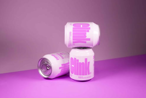 Three pink and white soda cans stacked on a pink background perfect for beverage packaging mockup. Ideal for designers needing creative product visuals.