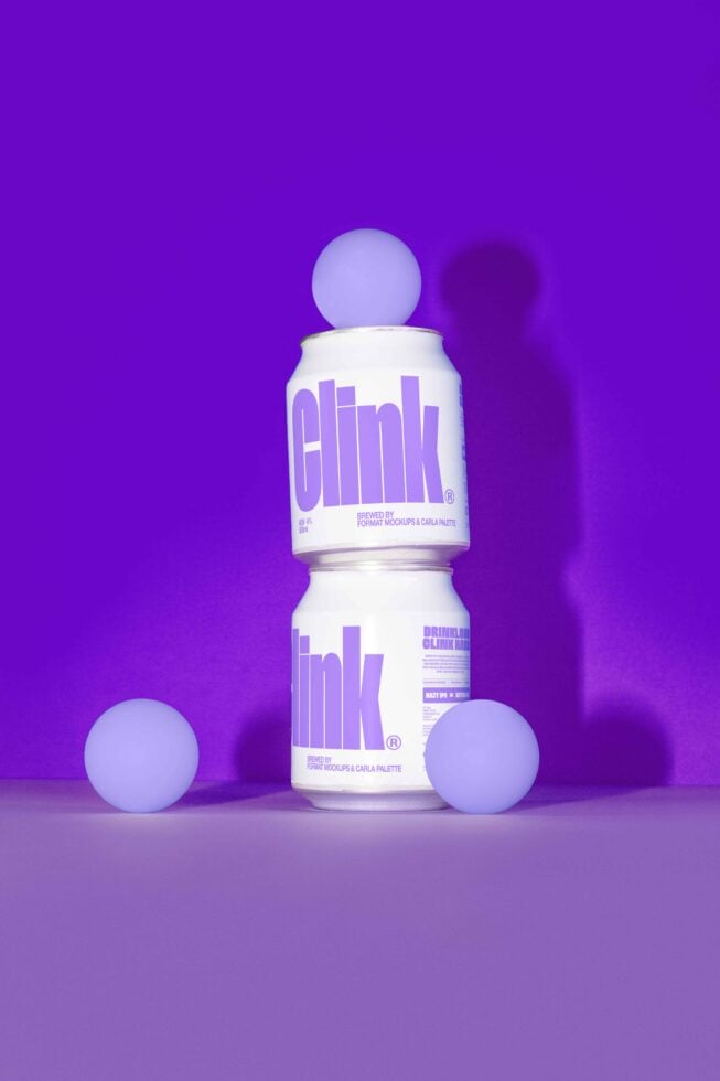 Sleek beverage mockup showcasing two white cans with purple text and glowing spheres on a vibrant purple background. Ideal for branding and advertising.