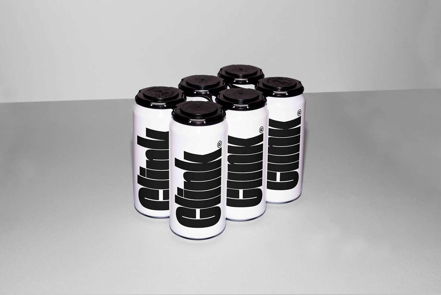 Six minimalist white beverage cans with bold black typography design on a gray background perfect for branding mockups and packaging design templates.