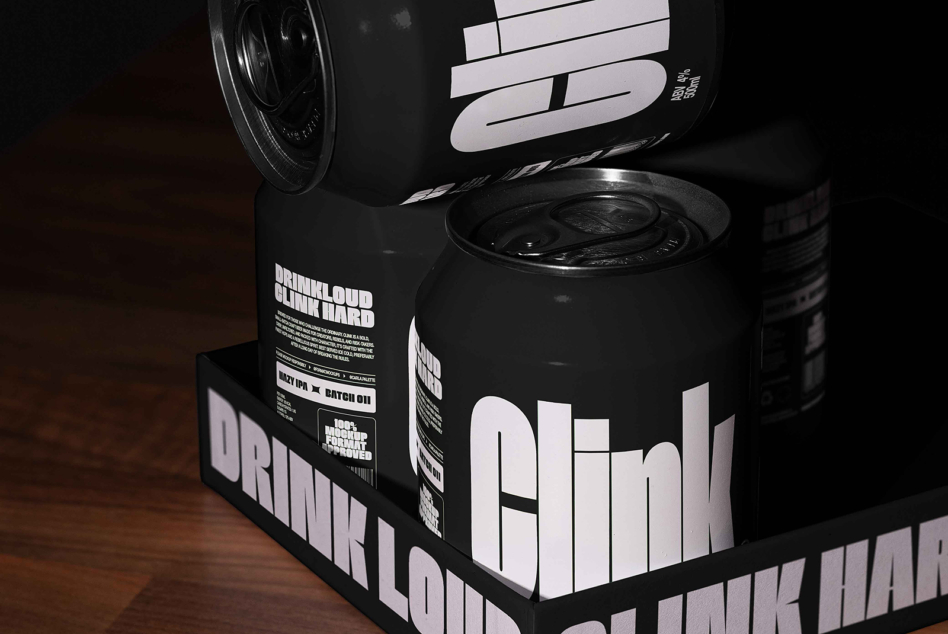 Black aluminum cans with white bold letterforms in branded retail box setup