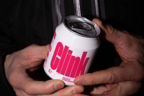 Mockup of a hand holding a beverage can with bold pink label Clink emphasizing branding design suitable for designers in digital asset marketplaces.