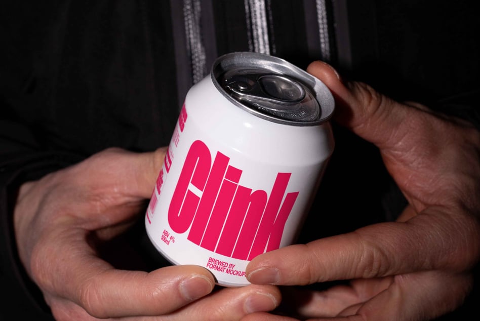 White beer can with hot pink vertical stripes held between two hands