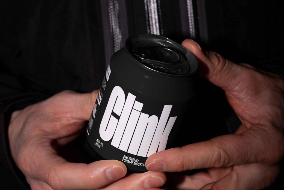 Dark beer can with white geometric wordmark held in person's hand