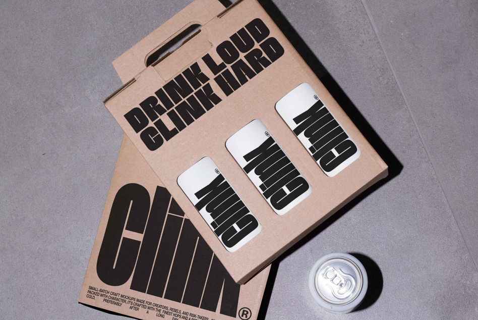 Kraft box displaying drink loud clink hard branding with three can mockups plus loose can below