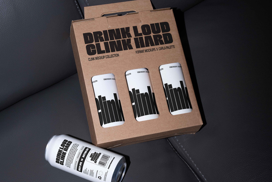 Kraft cardboard box with three cans showing clink mockup designs in black horizontal stripes