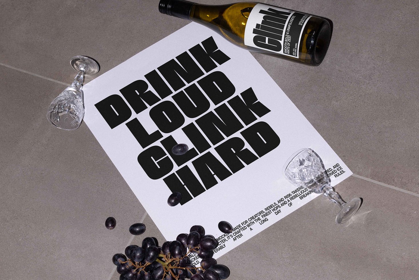 Bold font mockup on paper with text Drink Loud Clink Hard; includes wine bottle and glasses; ideal for poster design, typography, graphic templates.