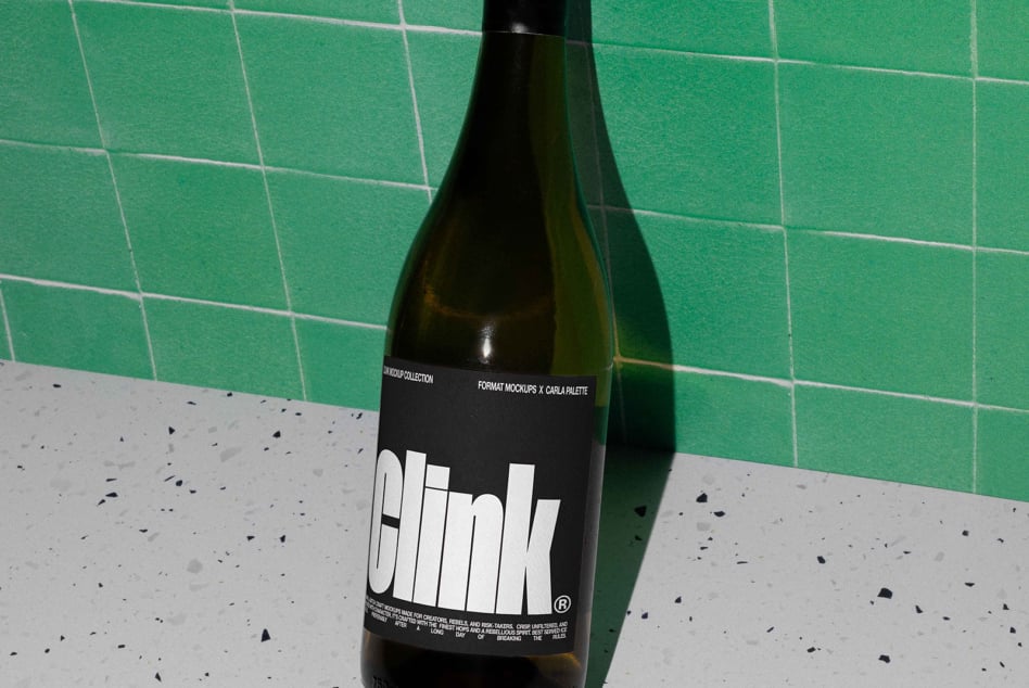 Dark bottle with white label on green tile wall, minimalist styling