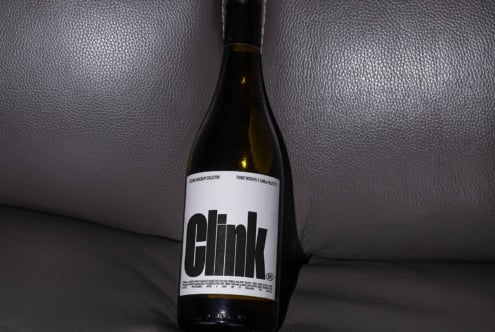 Minimalist wine bottle mockup featuring bold typography on a textured label ideal for design projects templates branding marketing packaging.