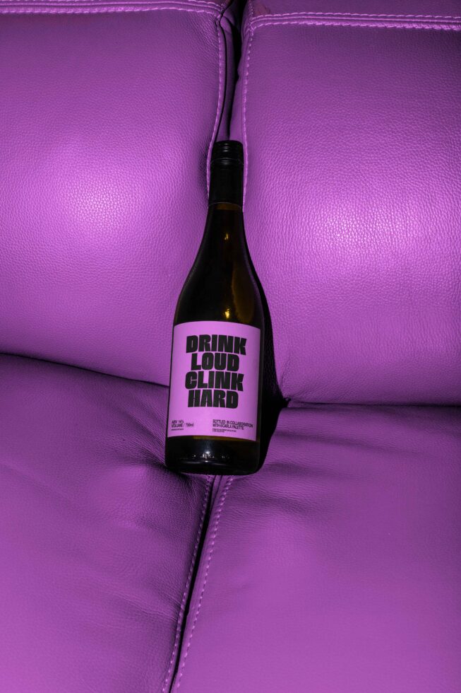 Wine bottle on purple leather couch mockup suitable for graphic designers branding alcohol packaging design digital assets marketing materials creative visuals