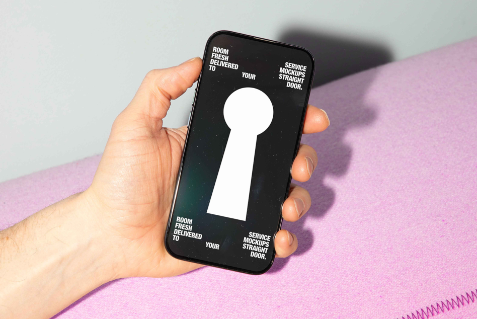 Hand holding phone showing white keyhole on dark background with text