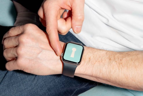 Smartwatch mockup on wrist displaying keyhole icon suitable for designers creating tech graphics digital assets templates and modern UI designs