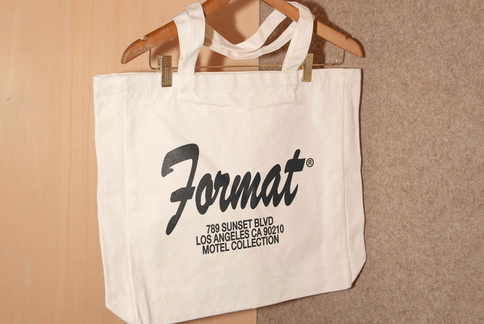 Cream canvas tote with Format script logo 789 Sunset Blvd address text