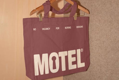 Maroon tote bag with bold white print saying no vacancy for boring designs. Perfect for designers seeking unique graphics and template ideas.