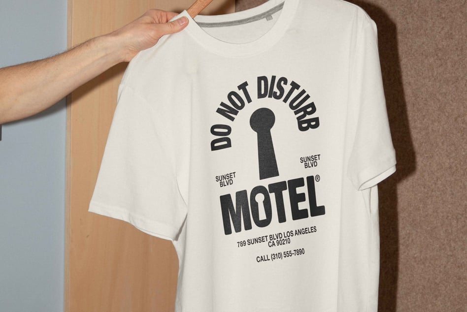 White t-shirt with Do Not Disturb Motel graphic text in bold black font, perfect for mockup designs or graphics projects by designers and creatives.