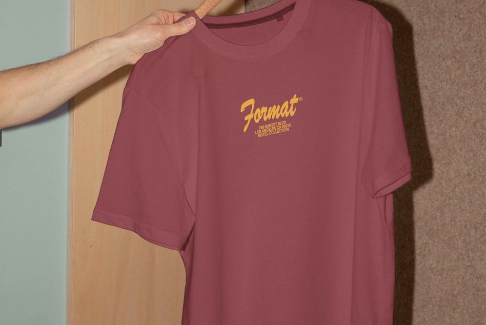 Mockup of a maroon t-shirt on a hanger with a yellow logo, ideal for designers. Apparel presentation, fashion design template for creative projects.