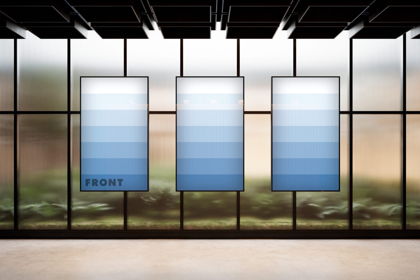 Three vertical poster frames in minimalist storefront with glass panels