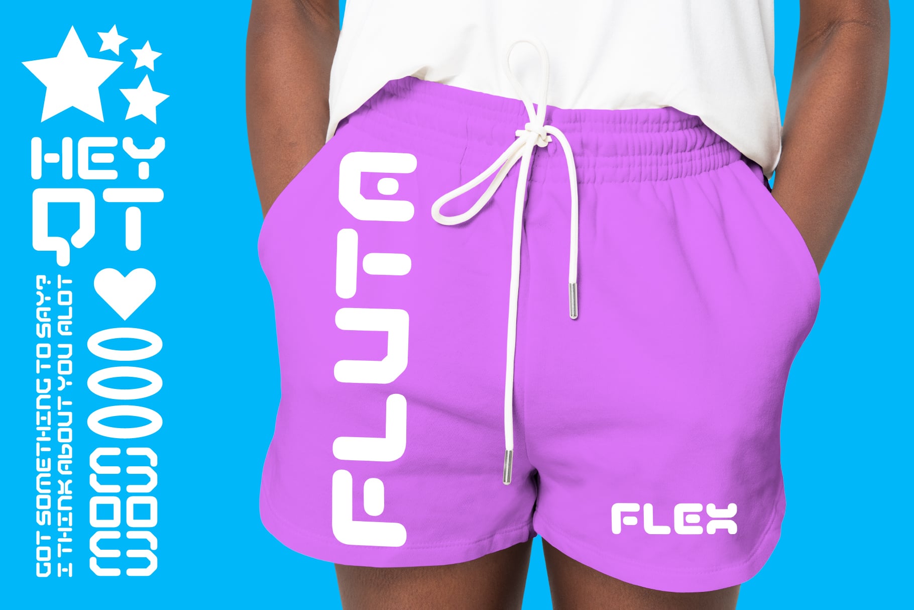 Bright purple shorts with large white text down the leg, drawstring waist, modeled on person
