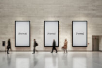 Three vertical framed blank displays mounted on concrete gallery wall with motion blur