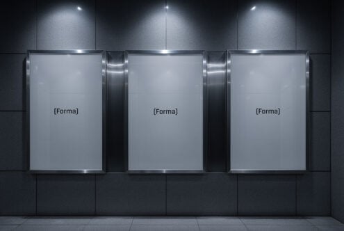 Three blank poster templates on a dark wall in a modern setting, minimalist design for mockups, ideal for showcasing graphics or advertising assets.