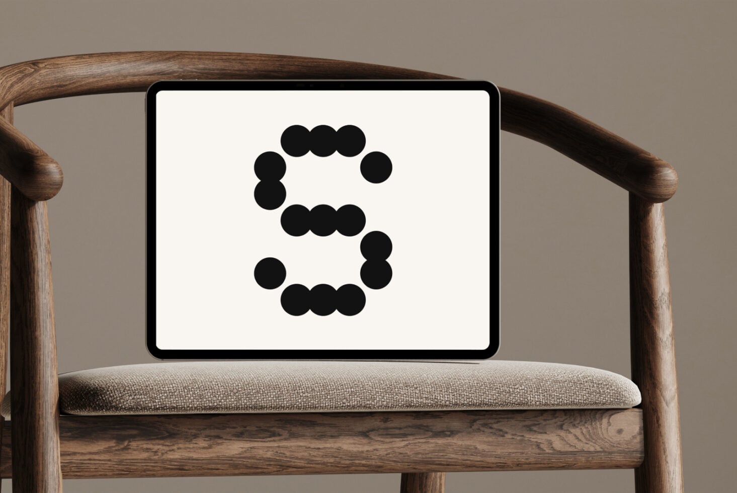 Mid-century chair with tablet showing black dot circle pattern number 5