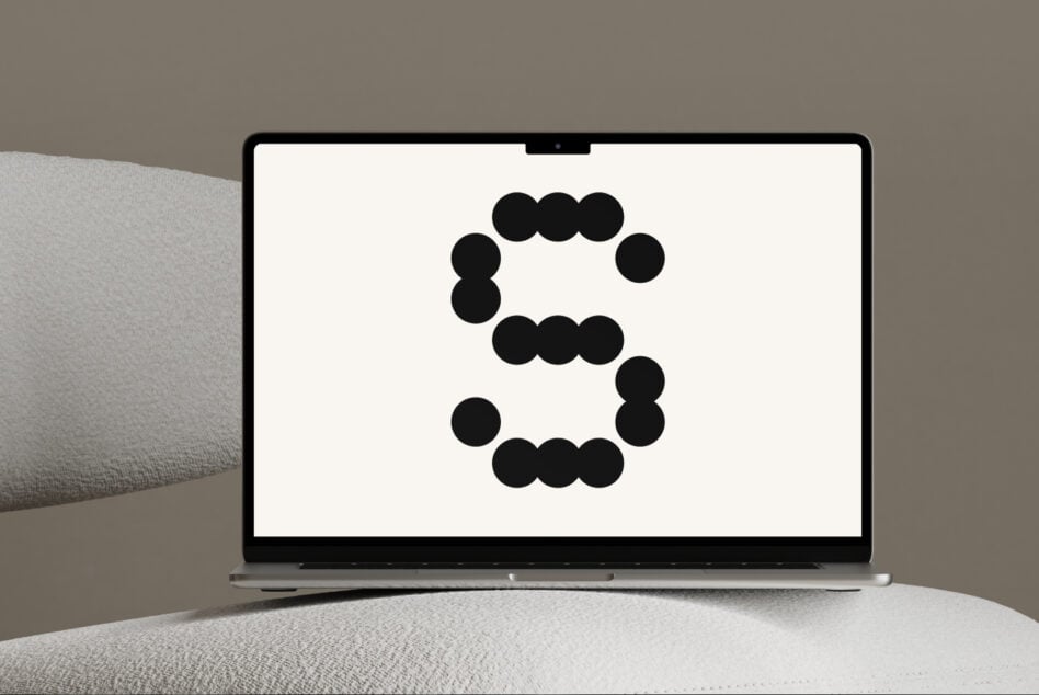 Overhead view of laptop showing dot circle pattern design on screen