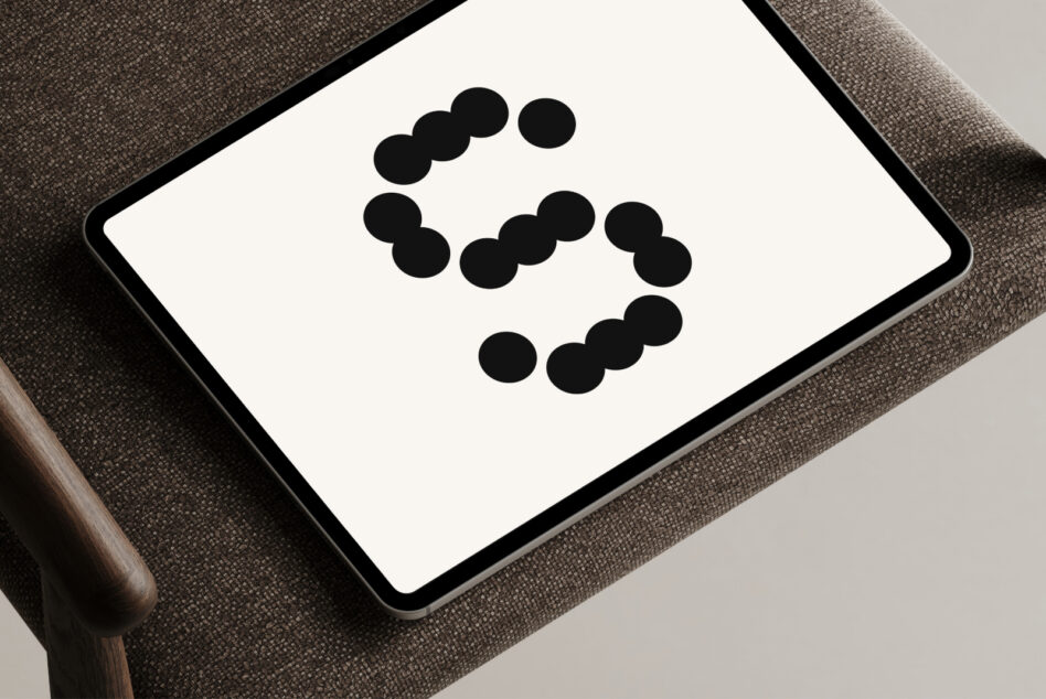 Tablet mockup displaying dot pattern logo on neutral fabric surface