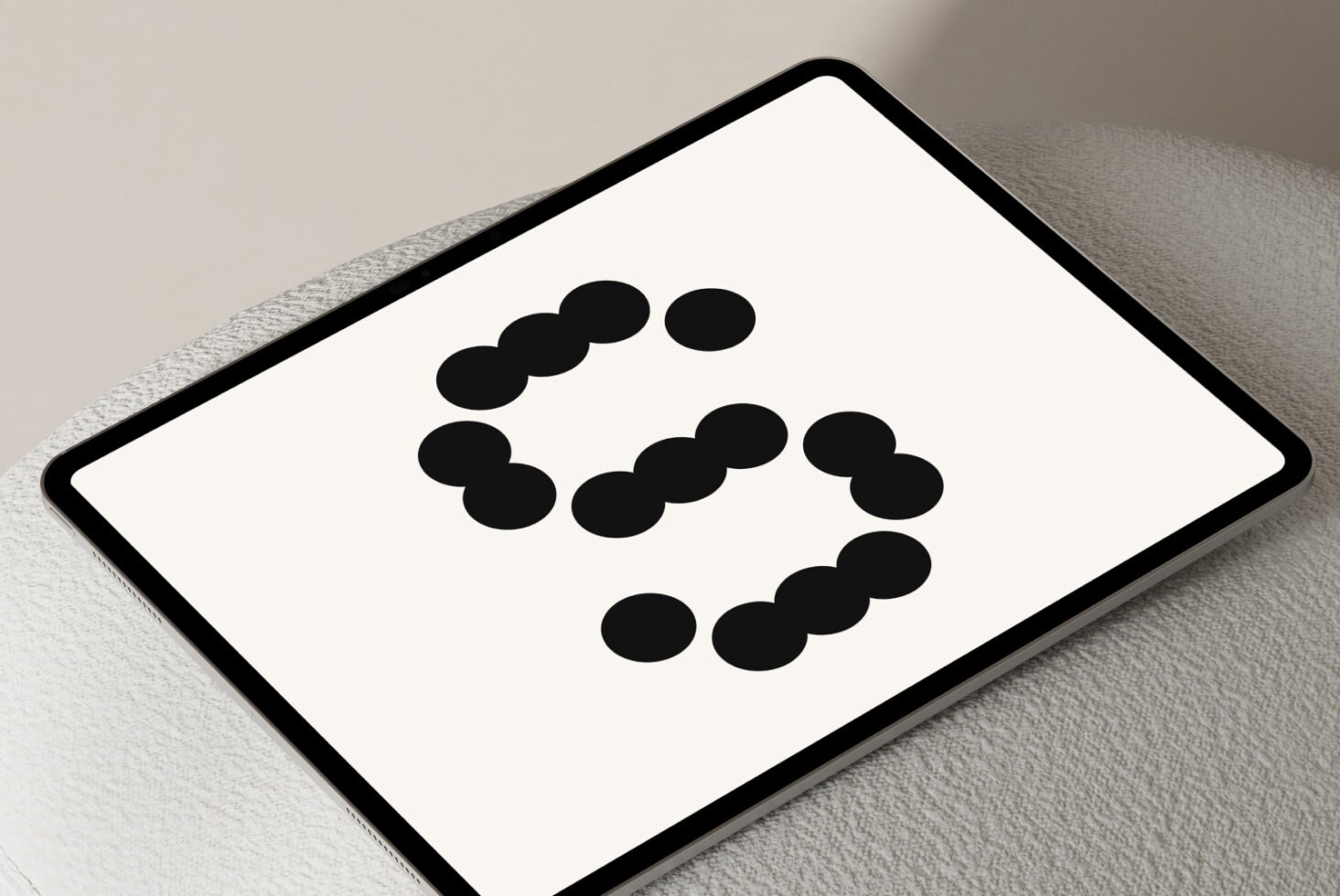 Modern tablet displaying abstract dotted font design on a neutral background suitable for graphic designers exploring typography and mockup projects.