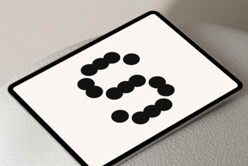 Modern tablet displaying abstract dotted font design on a neutral background suitable for graphic designers exploring typography and mockup projects.