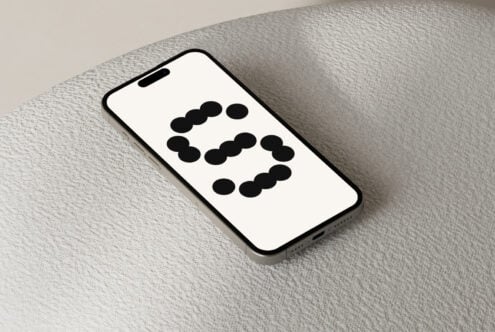 Smartphone screen showing minimalist dot matrix design on textured surface ideal for mockups templates digital assets designers looking for modern graphics