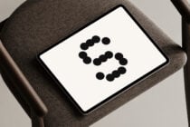 Tablet mockup on chair displaying dotted numeral 5. Perfect for designers needing minimalistic graphic templates. Ideal for showcasing digital assets.